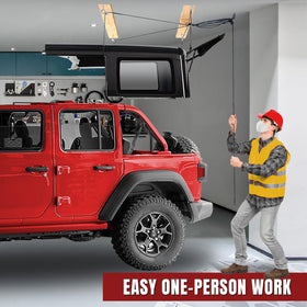 Jack Boss hoist in use as one person raises a Jeep Wrangler hardtop safely and smoothly