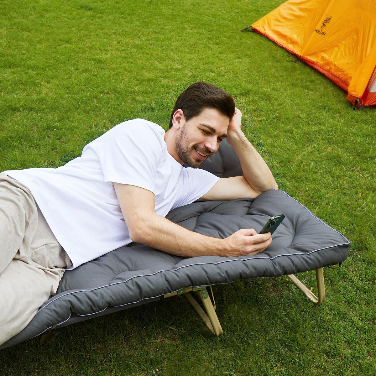 Jamdok topper laid on a camp cot inside tent demonstrating improved comfort