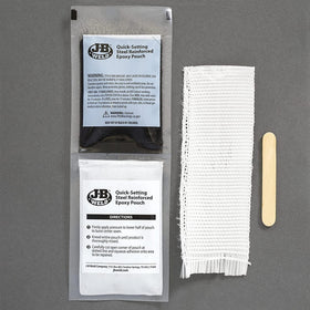 J-B Weld kit contents laid out with putty, cloth, sandpaper and applicator