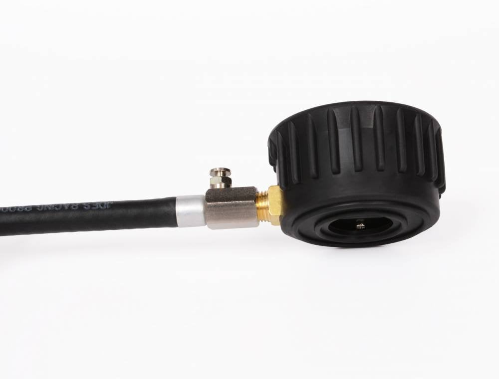 Joes Racing gauge attached to tire valve using flexible hose for convenient access