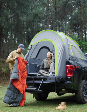 JOYTUTUS truck tent at night beside tailgate showing outdoor lifestyle use