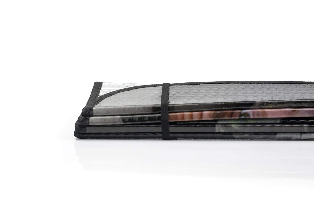 JUST FUNKY folded shade next to a notebook showing compact storage and portability benefit