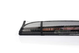 JUST FUNKY folded shade next to a notebook showing compact storage and portability benefit