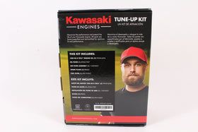 Technician installing Kawasaki tune-up kit parts on mower engine, demonstrating improved starting and reliability