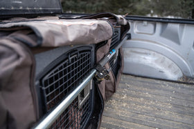 Keeper cargo bar in lifestyle scene stabilizing moving boxes for protected transit