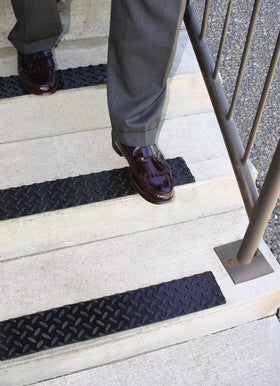 KEEPER scale comparison on a stair step showing 4 by 17.5 inch fit advantage