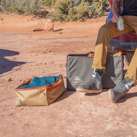 Kelty cargo box next to gear for size comparison and packing capacity benefit