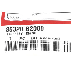 Kia Logo Assy-KIA SUB beside a ruler showing scale for accurate replacement