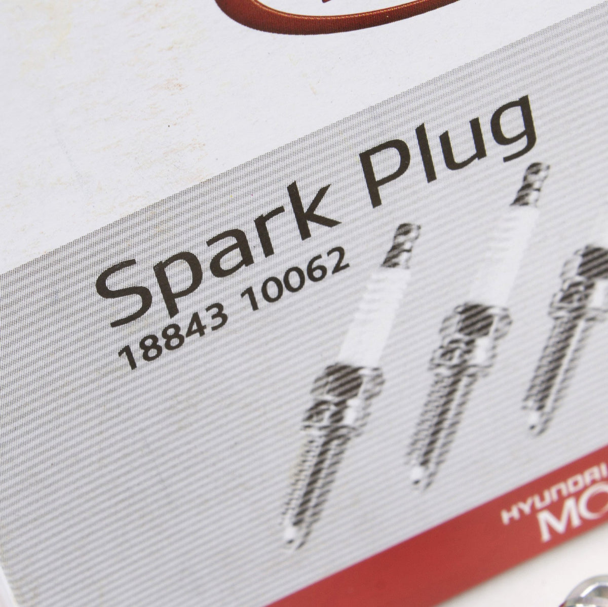 Close-up of Kia NGK spark plug electrode detail highlighting precise gap