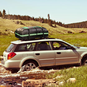 Kingfun rooftop carrier on car at campsite adding weatherproof storage