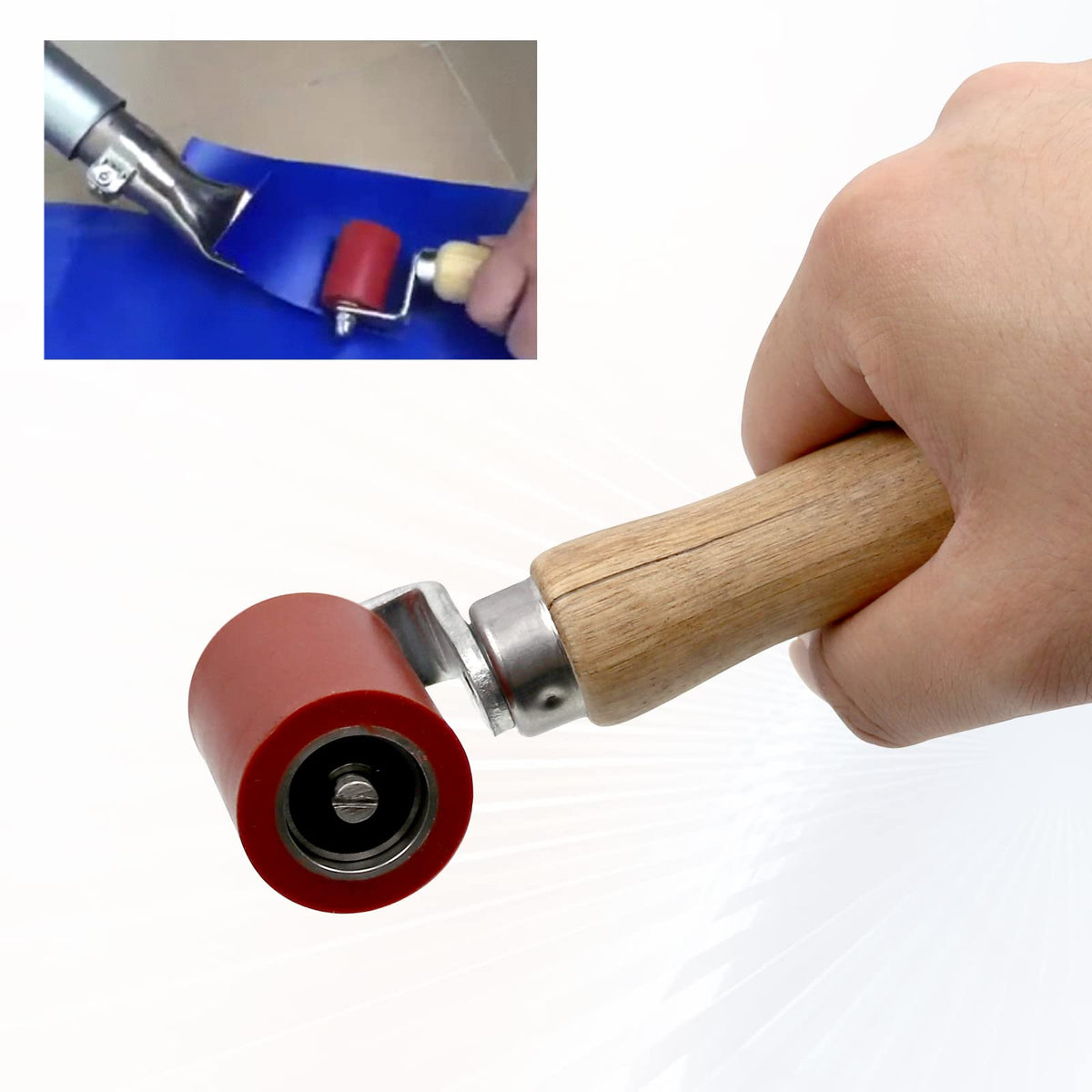 KOBSAINF seam roller beside a hand for scale showing compact, professional-ready size