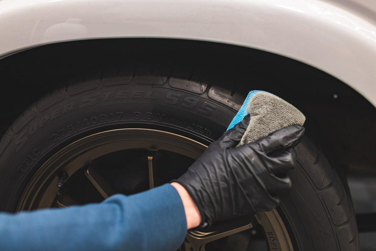 Side-by-side tire before and after KOCHCHEMIE glaze showing restored deep black