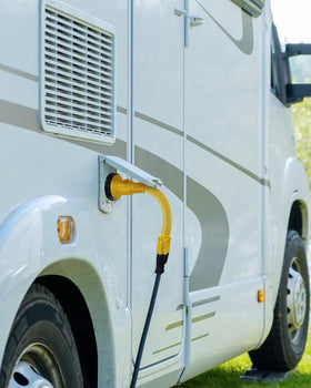 Kohree adapter connected between RV inlet and home outlet for temporary power use