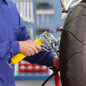 KRETLAW grease gun in use on an automotive ball joint demonstrating precise lubrication