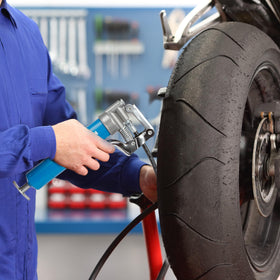KRETLAW grease gun in use on an automotive universal joint showing efficient lubrication