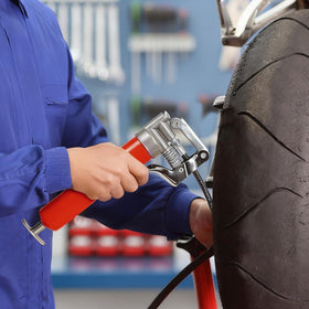 KRETLAW grease gun in use on car suspension showing precise targeted lubrication