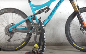 Kryptonite Evolution installed in garage securing motorcycle, provides fixed locking point
