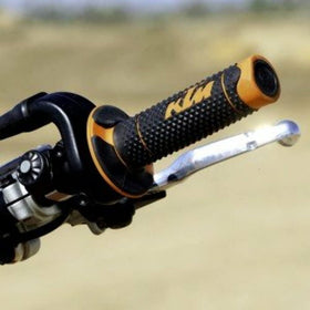 KTM grips on off-road bike in trail setting illustrating durability benefit