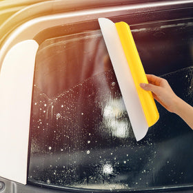 Lanties squeegee clearing shower glass to reduce water spots and streaks