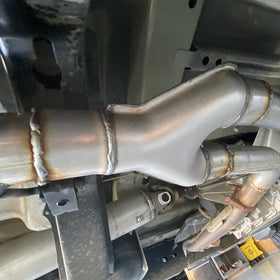 LCGP Y pipe in garage setup illustrating compatibility with custom exhaust work