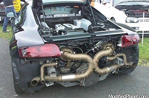 Mechanic fitting LEDAUT titanium header wrap in garage to lower under-hood heat