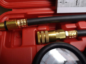 LEIMO KPARTS tester attached to an engine cylinder showing practical in-use diagnostic benefit