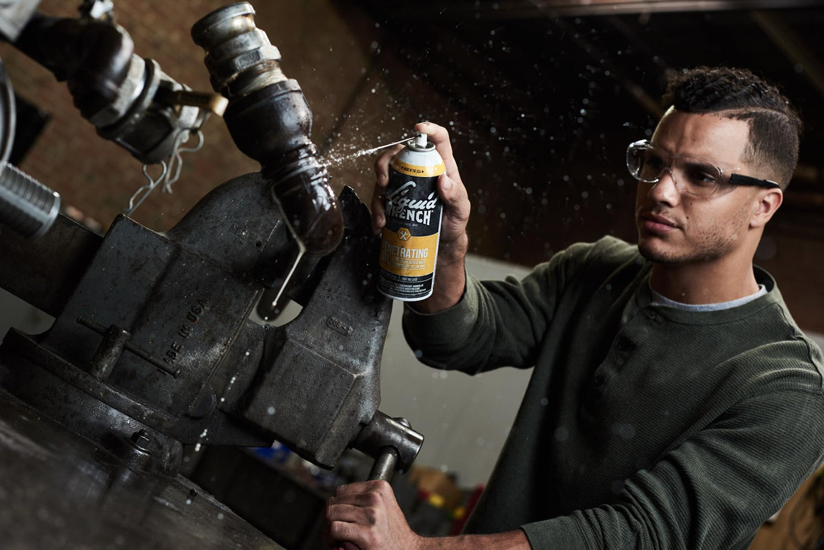 Liquid Wrench can beside hand tools to show scale and convenience for workshop use