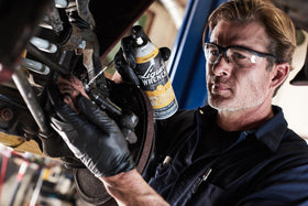 Liquid Wrench spraying onto a rusted bolt to free stuck hardware quickly and efficiently