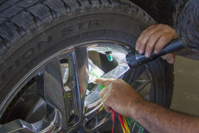 Lisle gauge in use on a brake caliper demonstrating quick in-place measurement benefit