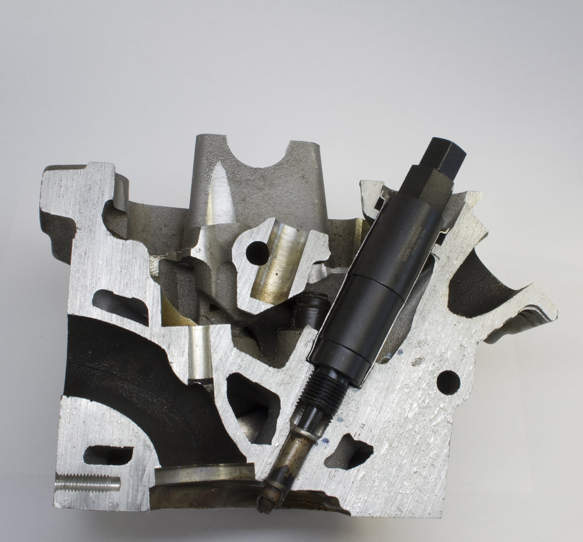 Lisle self-tapping puller cutting into seized metal plug tip to enable secure extraction