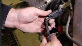 Lisle pliers next to ruler showing size and low-profile fit for tight spaces