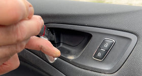 Lisle trim remover used to pry car door panel with reduced surface damage