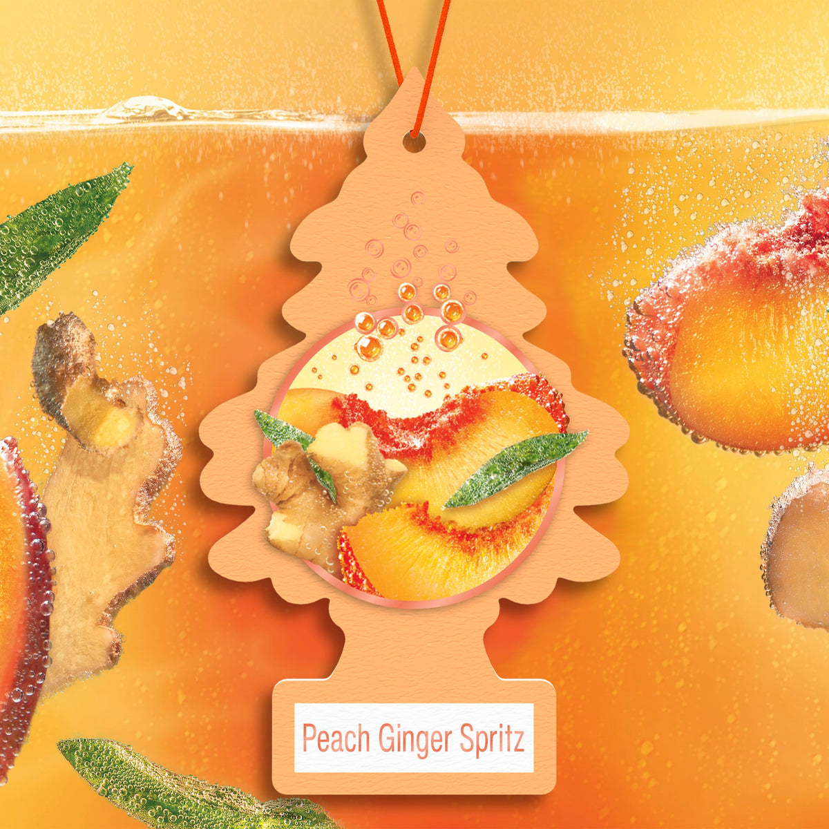 LITTLE TREES hanging from a car rearview providing fresh peach-ginger aroma while driving