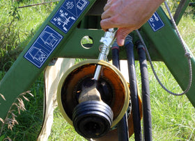 LockNLube beside a grease gun illustrating size and compatibility ease