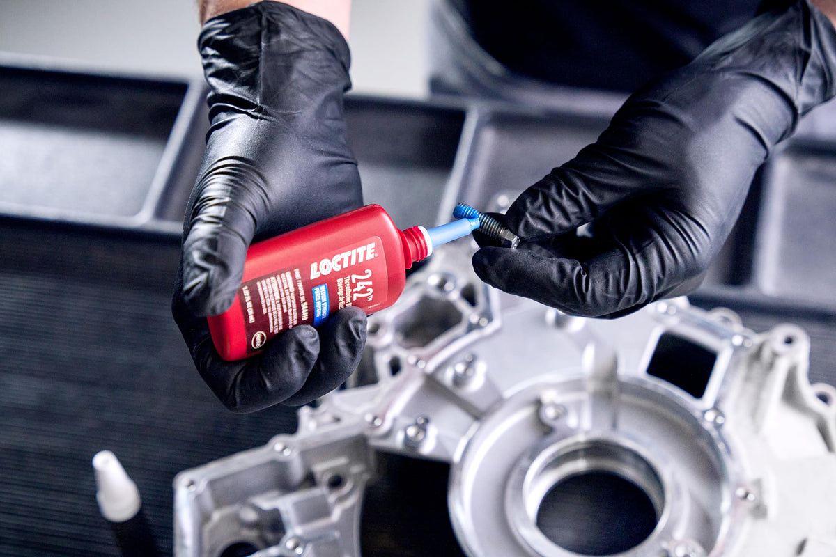Loctite bottle in garage setting illustrating reliable fastener security during repairs