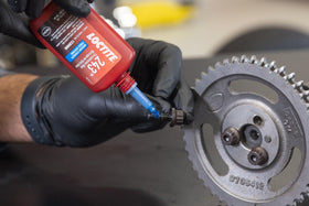 Mechanic using Loctite 243 during automotive assembly for reliability