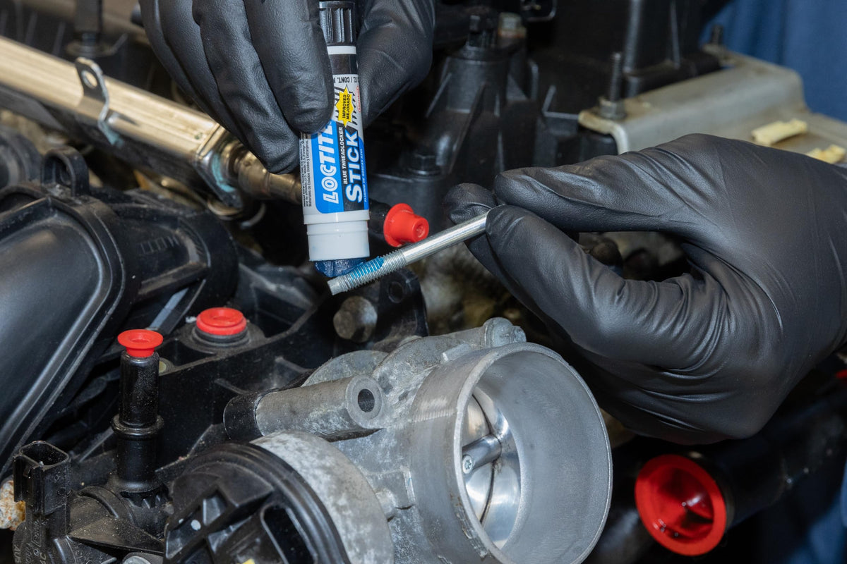 Loctite 504466 being applied to bolt threads to prevent loosening under vibration