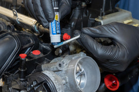Loctite 504466 being applied to bolt threads to prevent loosening under vibration