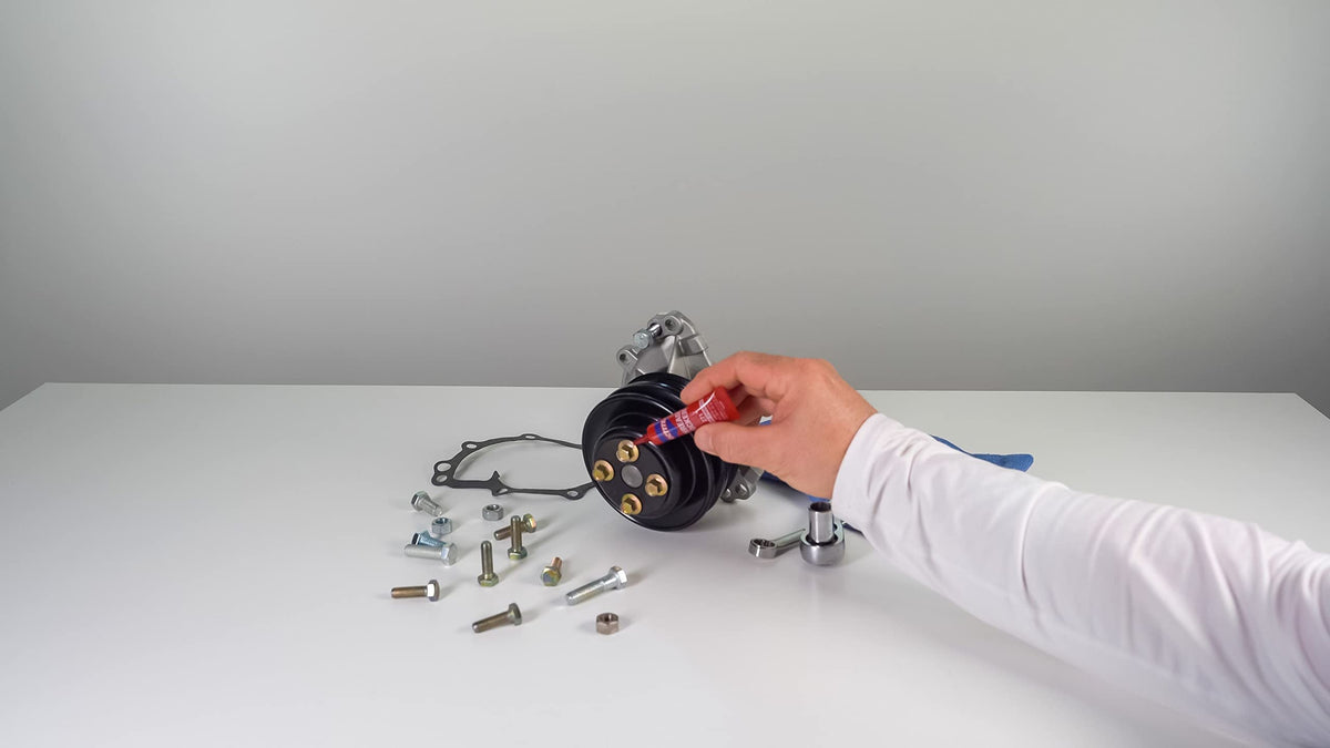 Loctite applied on engine bolt in workshop, protects critical components