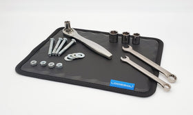 Lodesol pad placed on car fender holding bolts securely during repair