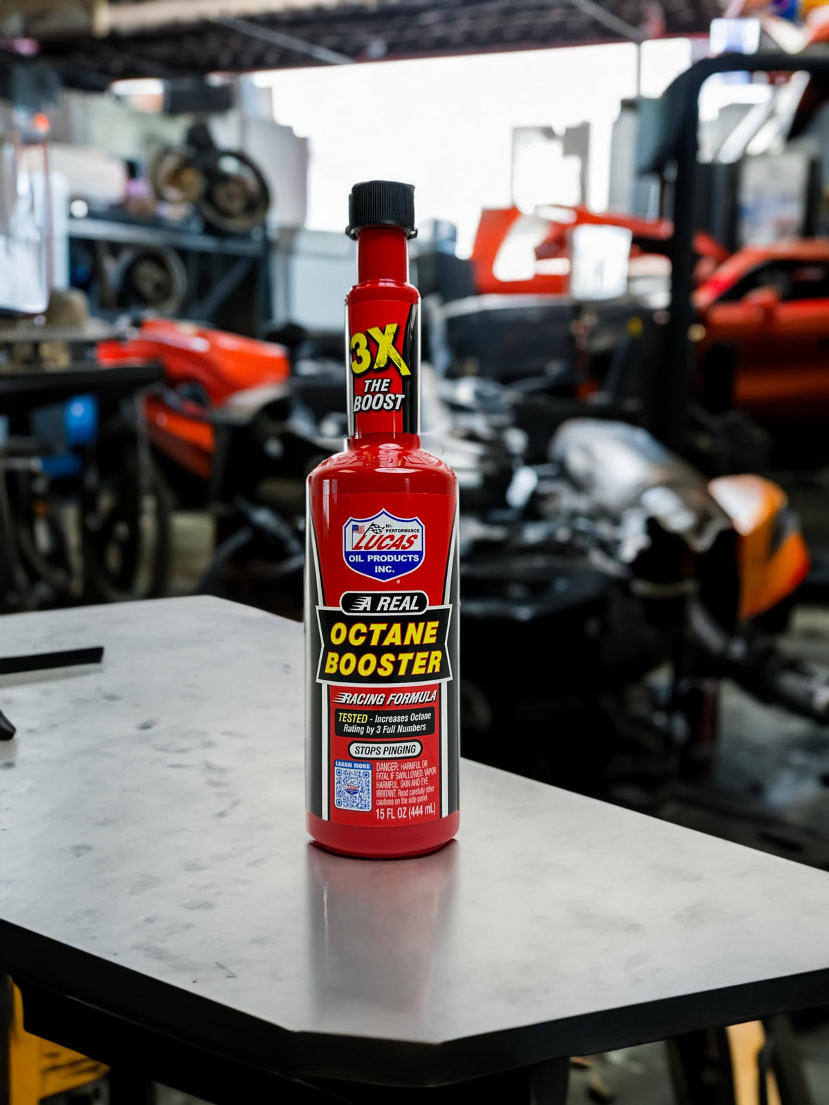 Lucas Oil octane booster on a garage workbench with tools showing ready-to-use convenience for mechanics
