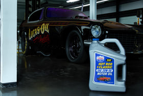 Lucas Oil five-quart container next to a common funnel showing scale benefit