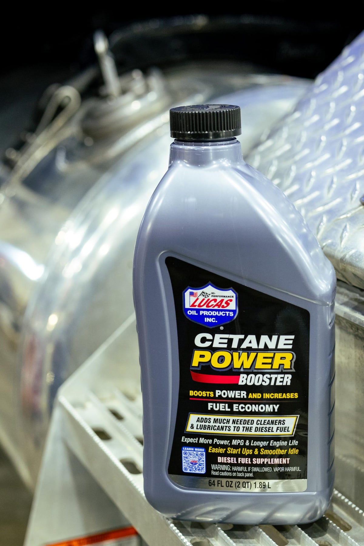 Lucas Oil cetane power booster being poured into a fuel funnel for easy dosing