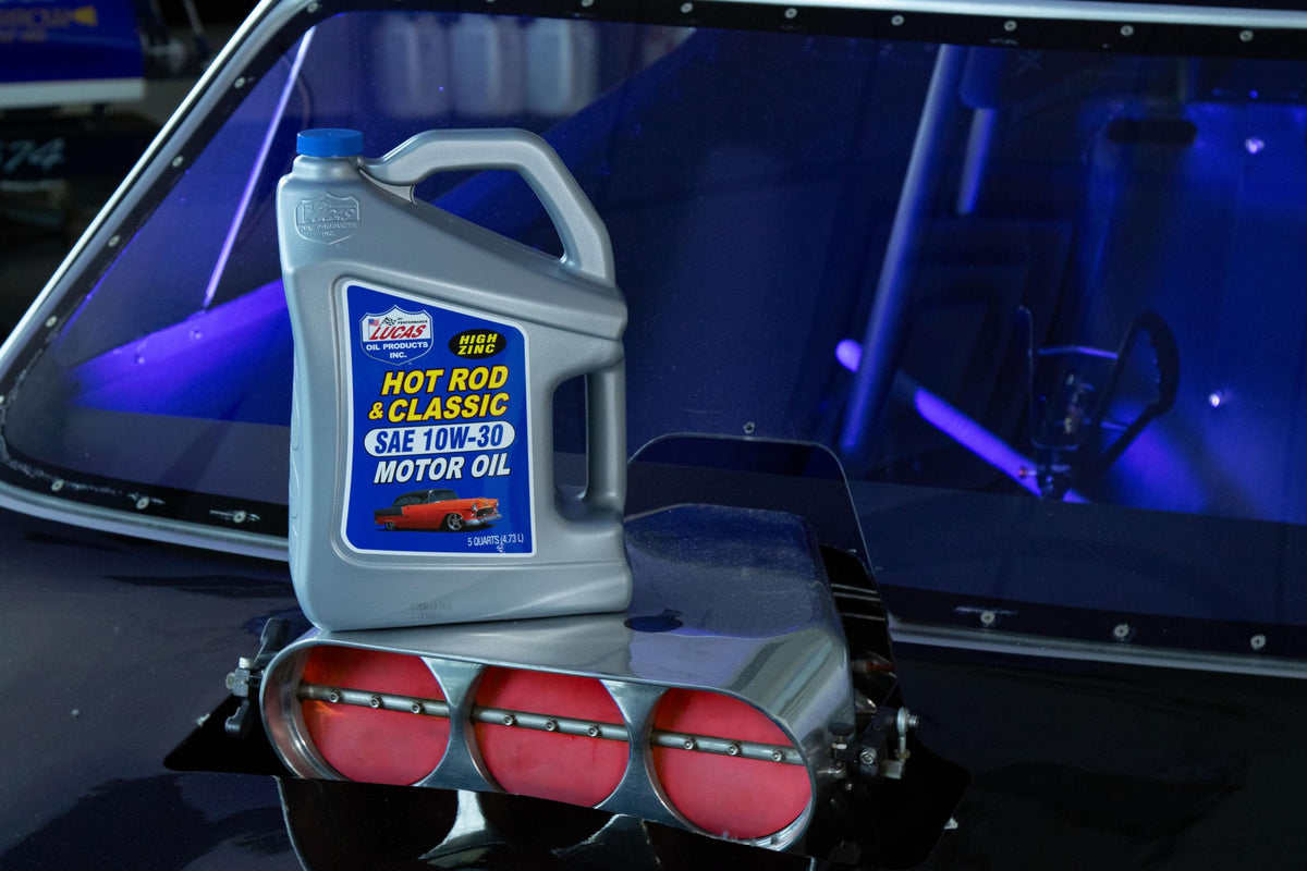Lucas Oil jug in a classic car garage setting suggesting preservation and care