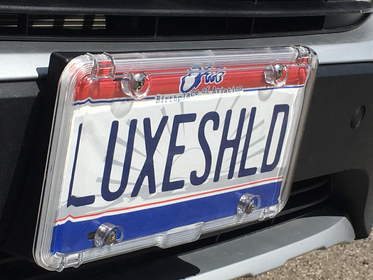 Luxe Shield on rear plate in a driveway demonstrating weather protection