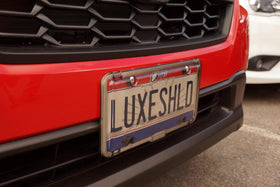 Luxe Shield next to standard license showing accurate scale and fitment