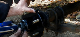 Mechanic using Lwlusup kit during trailer hub service illustrating ease of maintenance