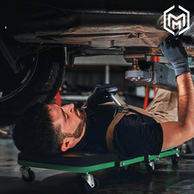 M-AUTO creeper in garage lifestyle scene illustrating real-world utility