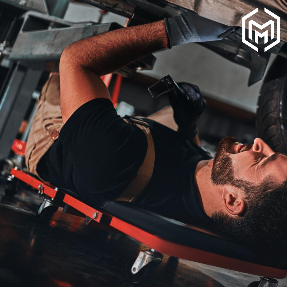 M-AUTO laid flat under a car enabling low underbody access and mobility