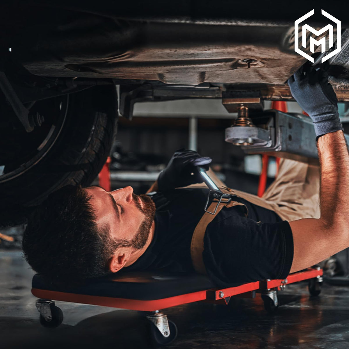 M-AUTO folded creeper stored upright in garage saving floor space